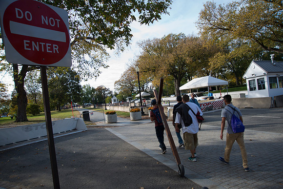 Man with cross walks around The White House during election day.