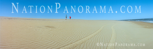Father and son walking along beach