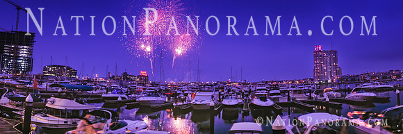 Fireworks over docked boats on water