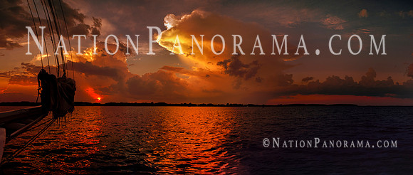 Sailing toward stormcloud at sunset